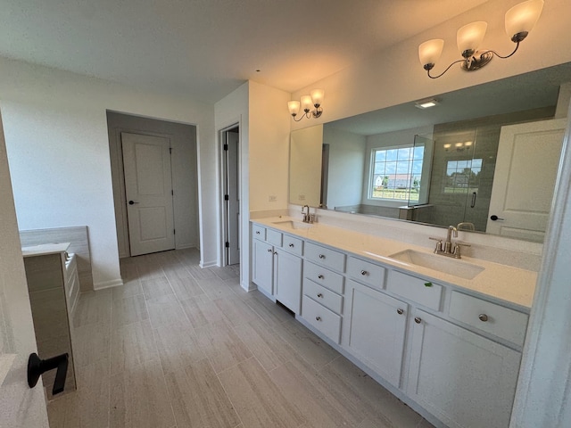 627 Henry Ln, Oswego, IL 60543 - bathroom featuring a chandelier, double vanity, and a stall shower