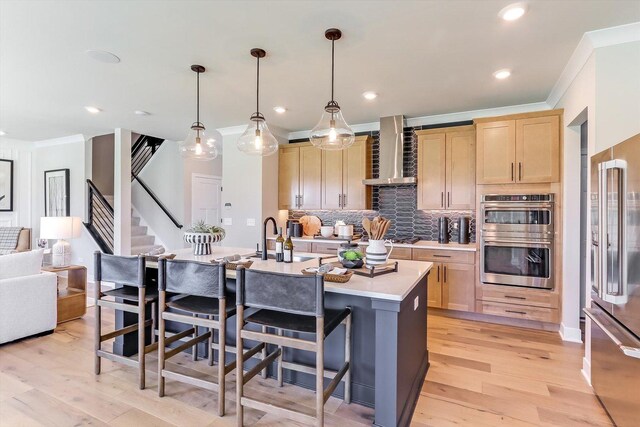 627 Henry Ln, Oswego, IL 60543 - kitchen featuring wall chimney exhaust hood, appliances with stainless steel finishes, ornamental molding, light countertops, and light brown cabinetry
