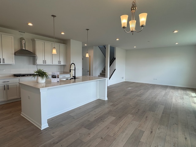 627 Henry Ln, Oswego, IL 60543 - kitchen with wall chimney exhaust hood, hardwood / wood-style floors, a center island with sink, open floor plan, and recessed lighting