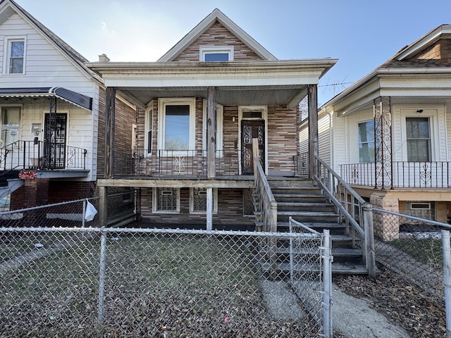 8216 S Brandon Ave, Chicago, IL 60617 - shotgun-style home featuring covered porch and a fenced front yard