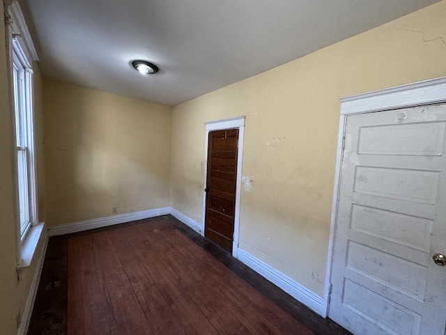 8216 S Brandon Ave, Chicago, IL 60617 - unfurnished room featuring baseboards and dark wood-type flooring