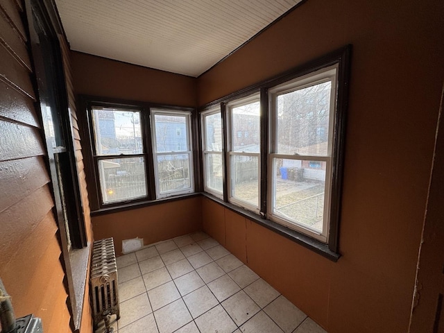 8216 S Brandon Ave, Chicago, IL 60617 - unfurnished sunroom with radiator heating unit and tile patterned floors