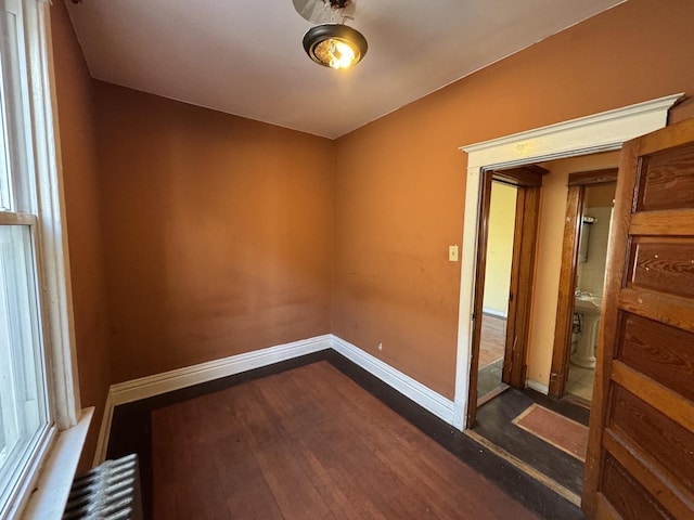 8216 S Brandon Ave, Chicago, IL 60617 - spare room featuring baseboards, wood finished floors, and radiator heating unit