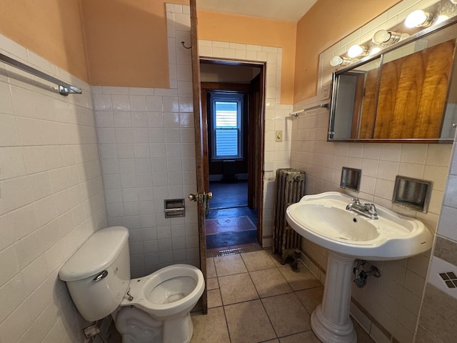 8216 S Brandon Ave, Chicago, IL 60617 - bathroom with toilet, a sink, radiator, tile patterned flooring, and tile walls