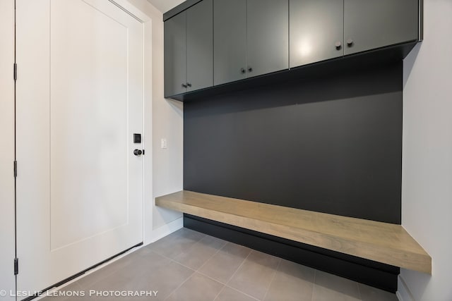 mudroom with baseboards and tile patterned flooring