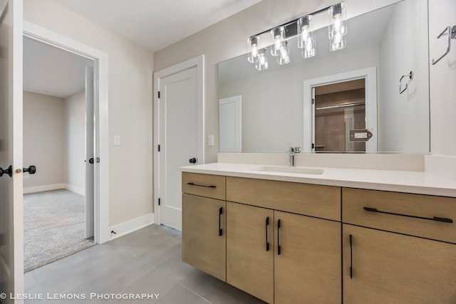 bathroom featuring baseboards, vanity, and tile patterned floors