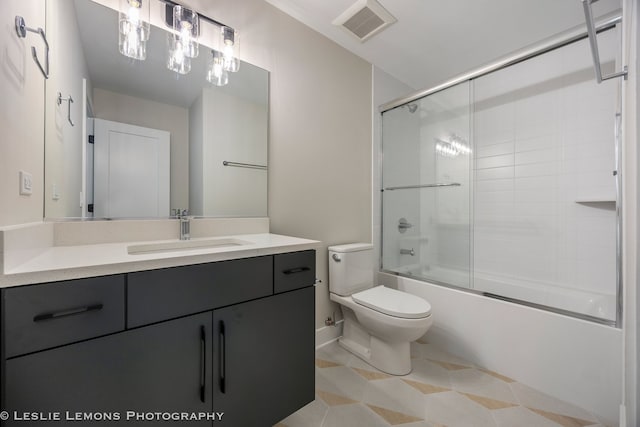 bathroom with shower / bath combination with glass door, toilet, visible vents, tile patterned flooring, and vanity