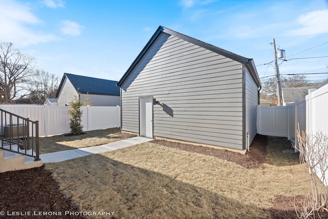 view of home's exterior with a fenced backyard and a lawn