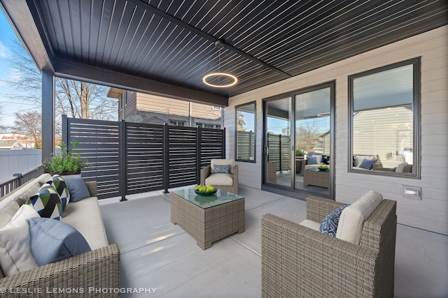 view of patio / terrace featuring outdoor lounge area and fence