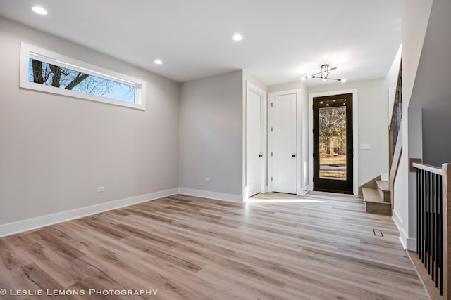 foyer featuring light wood-type flooring, baseboards, and recessed lighting