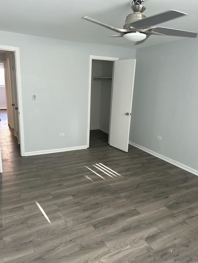 unfurnished bedroom with baseboards, a closet, wood finished floors, and ceiling fan