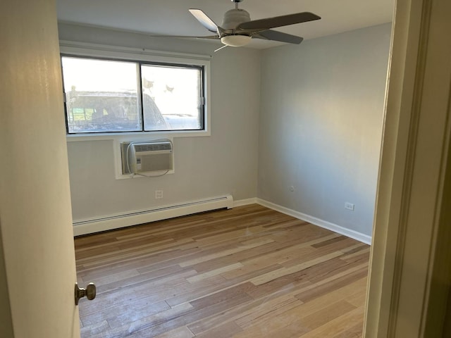 empty room with a wall mounted AC, baseboard heating, light wood-style flooring, baseboards, and ceiling fan