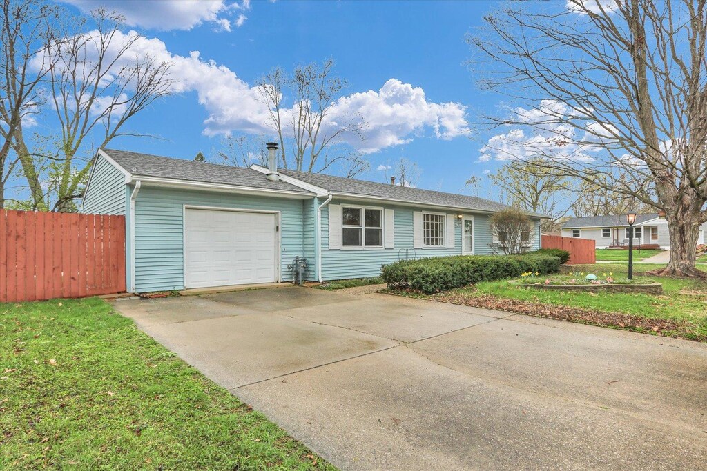 1801 Winchester Dr, Champaign, IL 61821 - ranch-style house featuring a garage, a front lawn, fence, and concrete driveway