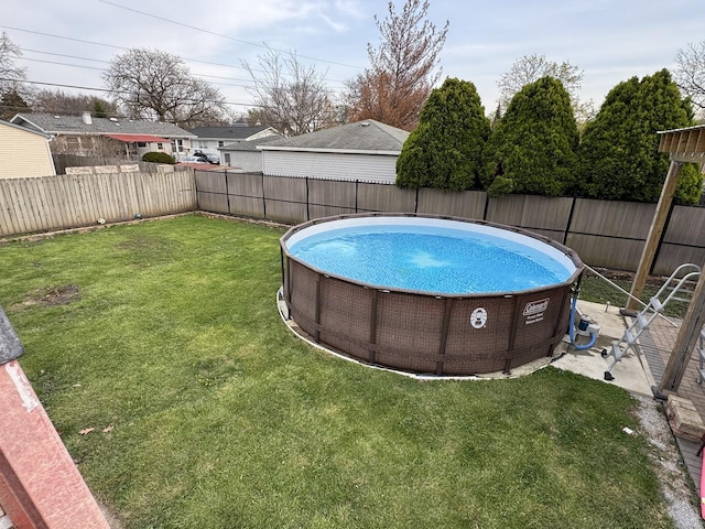 view of swimming pool with a fenced in pool, a yard, and a fenced backyard