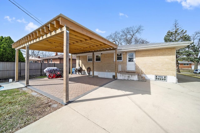 view of patio / terrace featuring a carport and fence