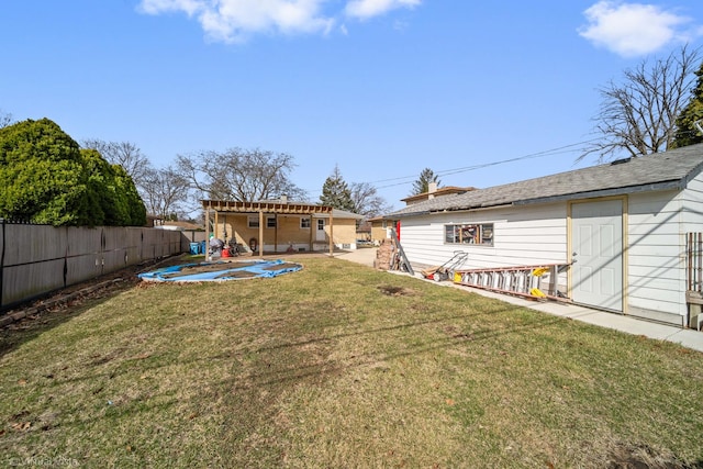 view of yard featuring an outdoor structure, a patio, and a fenced backyard