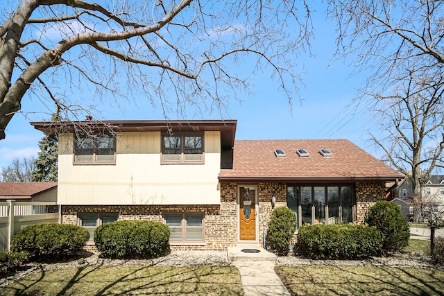 tri-level home with brick siding
