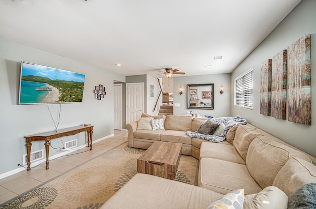 tiled living area with baseboards, visible vents, stairway, and a ceiling fan