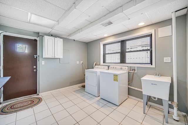 laundry area featuring visible vents, baseboards, laundry area, washing machine and dryer, and light tile patterned floors