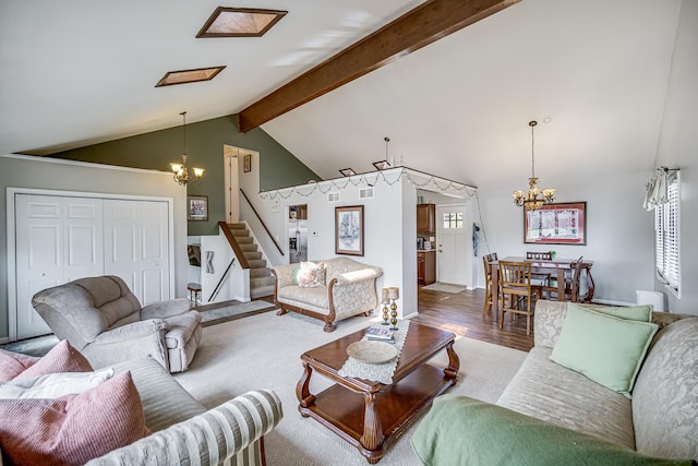 living room featuring vaulted ceiling with beams, a notable chandelier, wood finished floors, and stairs