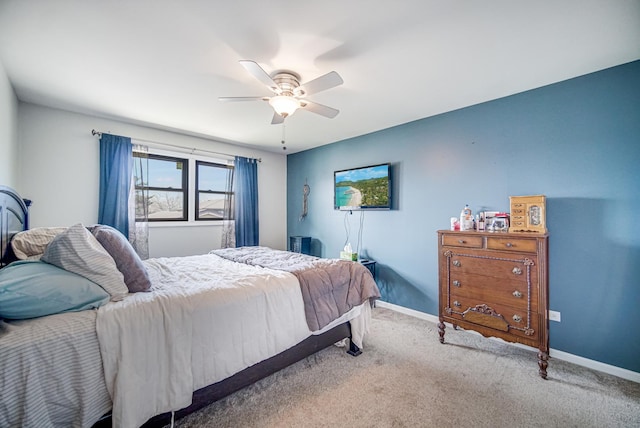 carpeted bedroom featuring baseboards and a ceiling fan