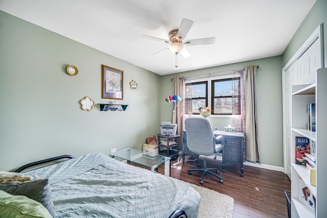 bedroom with baseboards, wood finished floors, and a ceiling fan