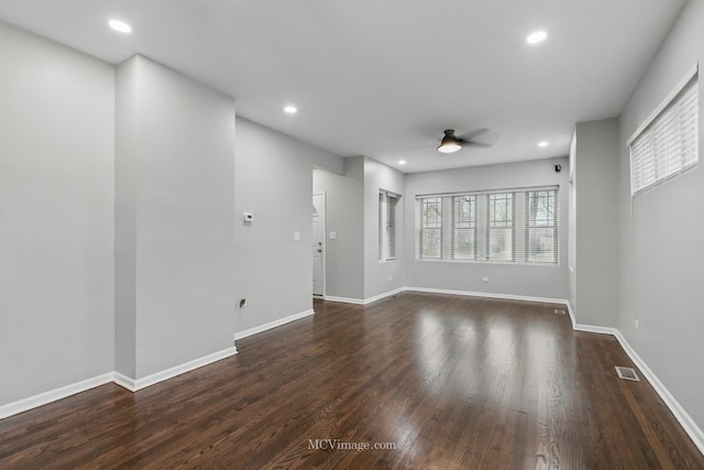 unfurnished living room featuring dark wood finished floors, recessed lighting, ceiling fan, and baseboards