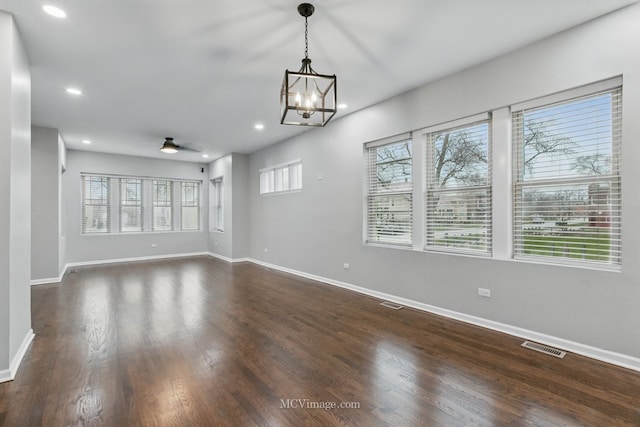 interior space with visible vents, dark wood-style floors, baseboards, recessed lighting, and ceiling fan with notable chandelier