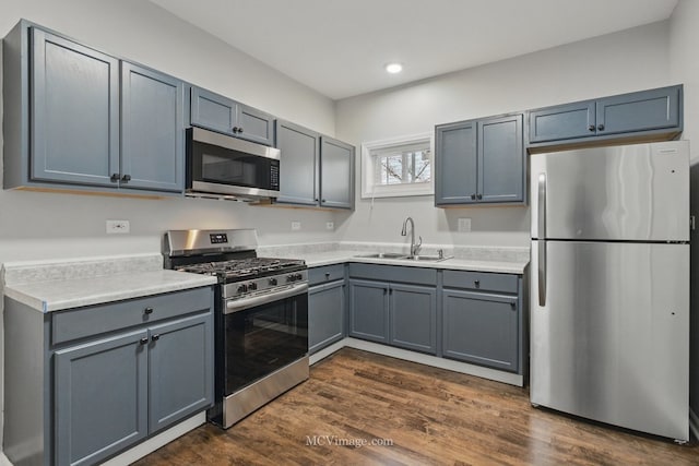 kitchen featuring recessed lighting, a sink, stainless steel appliances, and light countertops