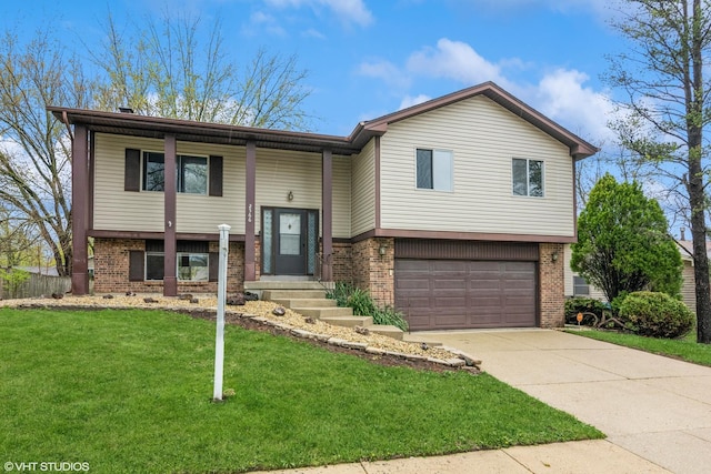 bi-level home with brick siding, a front yard, and a garage