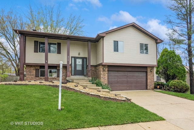 bi-level home featuring brick siding, a front yard, and a garage