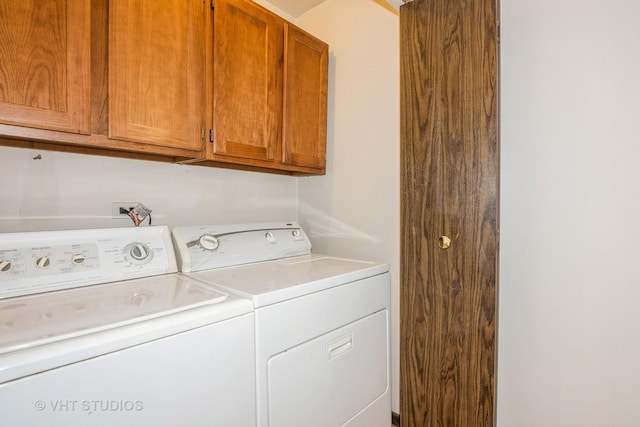 washroom featuring cabinet space and washer and dryer