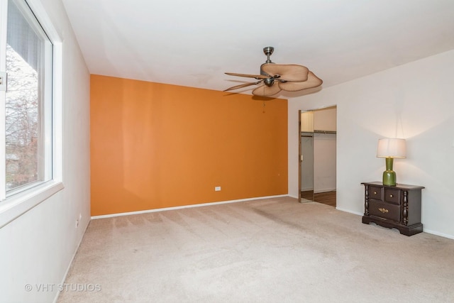 unfurnished bedroom featuring baseboards, a ceiling fan, carpet flooring, and a closet
