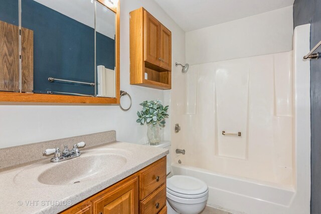 bathroom with toilet, vanity, and bathtub / shower combination