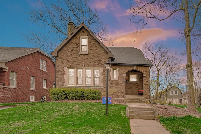 1739 Cedar Rd, Homewood, IL 60430 - view of front facade with a yard, brick siding, a chimney, and a shingled roof