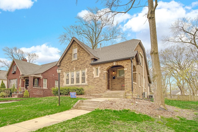 1739 Cedar Rd, Homewood, IL 60430 - english style home with brick siding, fence, a front yard, and roof with shingles