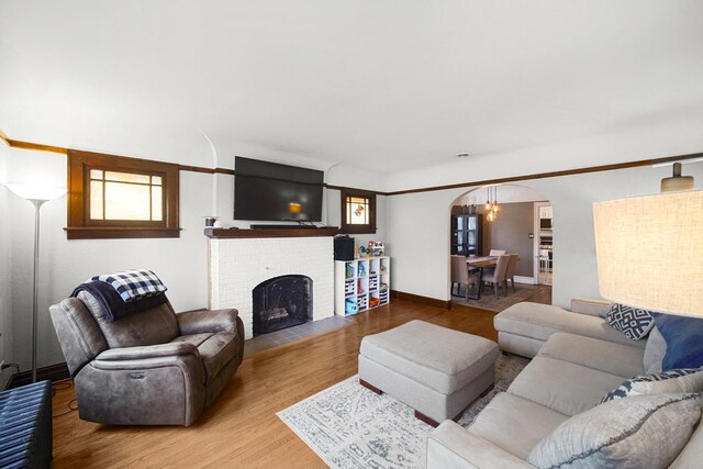 1739 Cedar Rd, Homewood, IL 60430 - living area with arched walkways, a brick fireplace, and wood finished floors