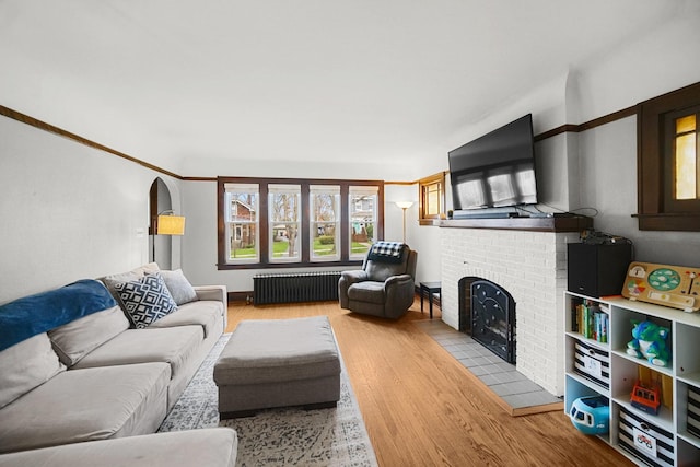 1739 Cedar Rd, Homewood, IL 60430 - living area with a brick fireplace, radiator heating unit, and wood finished floors