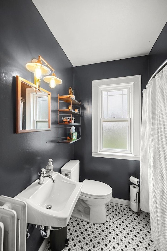 1739 Cedar Rd, Homewood, IL 60430 - bathroom with a sink, baseboards, toilet, lofted ceiling, and radiator