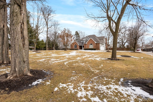523 Ingalton Ave, West Chicago, IL 60185 - yard layered in snow featuring fence and a garage