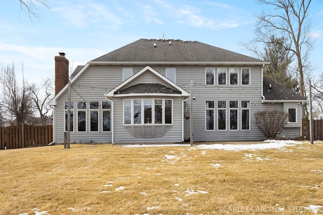 523 Ingalton Ave, West Chicago, IL 60185 - rear view of property with a chimney, a shingled roof, fence, and a yard