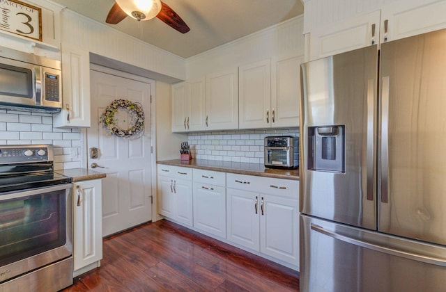 kitchen with white cabinets, a ceiling fan, appliances with stainless steel finishes, and dark wood-type flooring