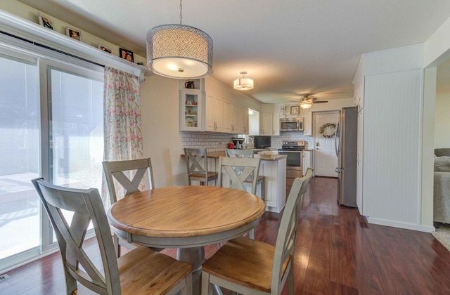 dining area with dark wood-style floors and a ceiling fan