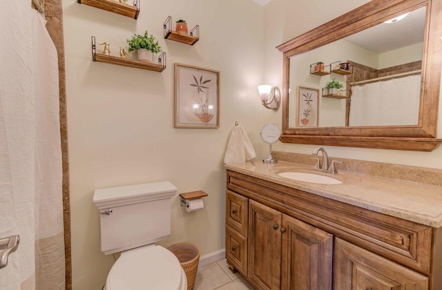 bathroom with tile patterned floors, toilet, curtained shower, vanity, and baseboards