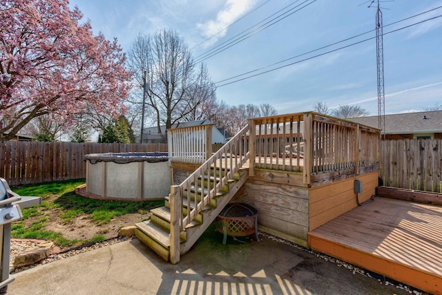 deck featuring stairs, fence, and a fenced in pool
