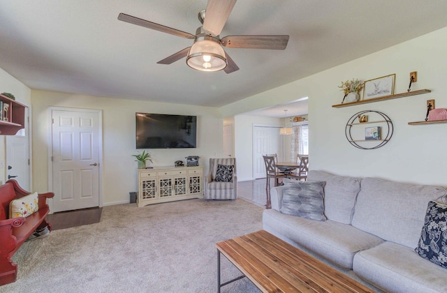 living room featuring carpet floors and a ceiling fan