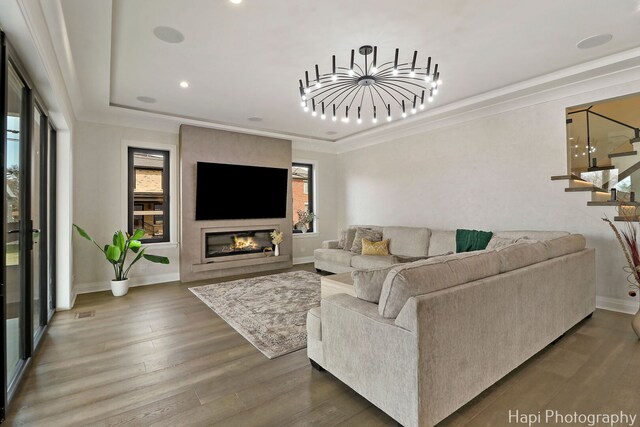 1906 Lee St, Des Plaines, IL 60018 - living area with crown molding, a glass covered fireplace, wood finished floors, and baseboards