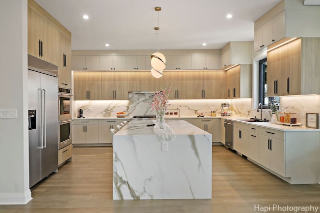 1906 Lee St, Des Plaines, IL 60018 - kitchen with a sink, light stone countertops, light wood-style flooring, and a center island