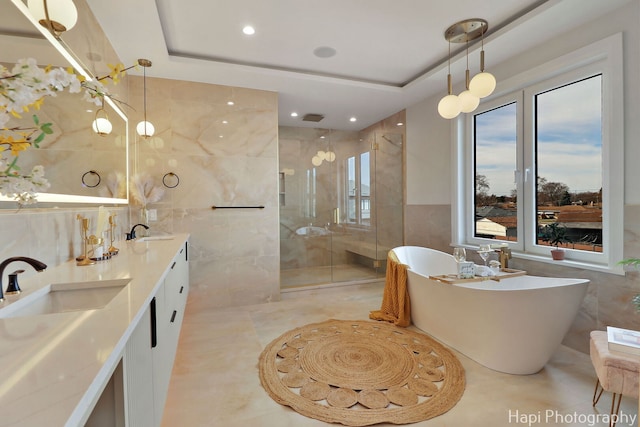 1906 Lee St, Des Plaines, IL 60018 - bathroom with tile walls, a stall shower, a soaking tub, and a sink