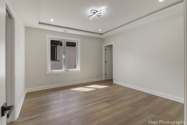 1906 Lee St, Des Plaines, IL 60018 - unfurnished room featuring recessed lighting, a raised ceiling, wood finished floors, and baseboards